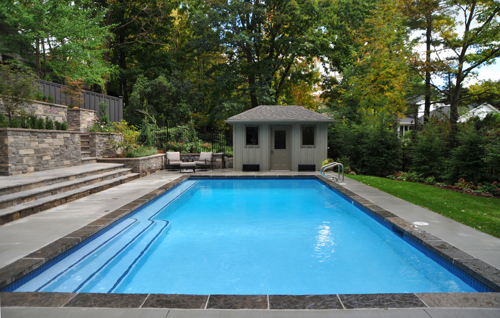 Example of a huge minimalist backyard rectangular pool house design in Toronto