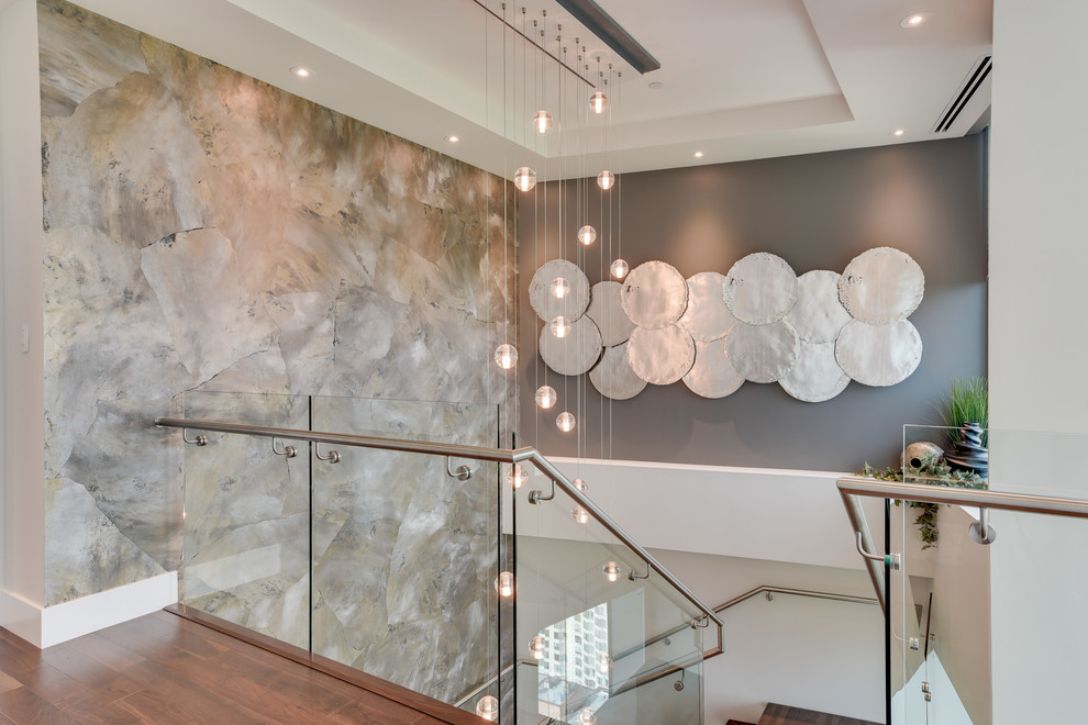 Photo of an expansive contemporary wood u-shaped staircase in Calgary with open risers.