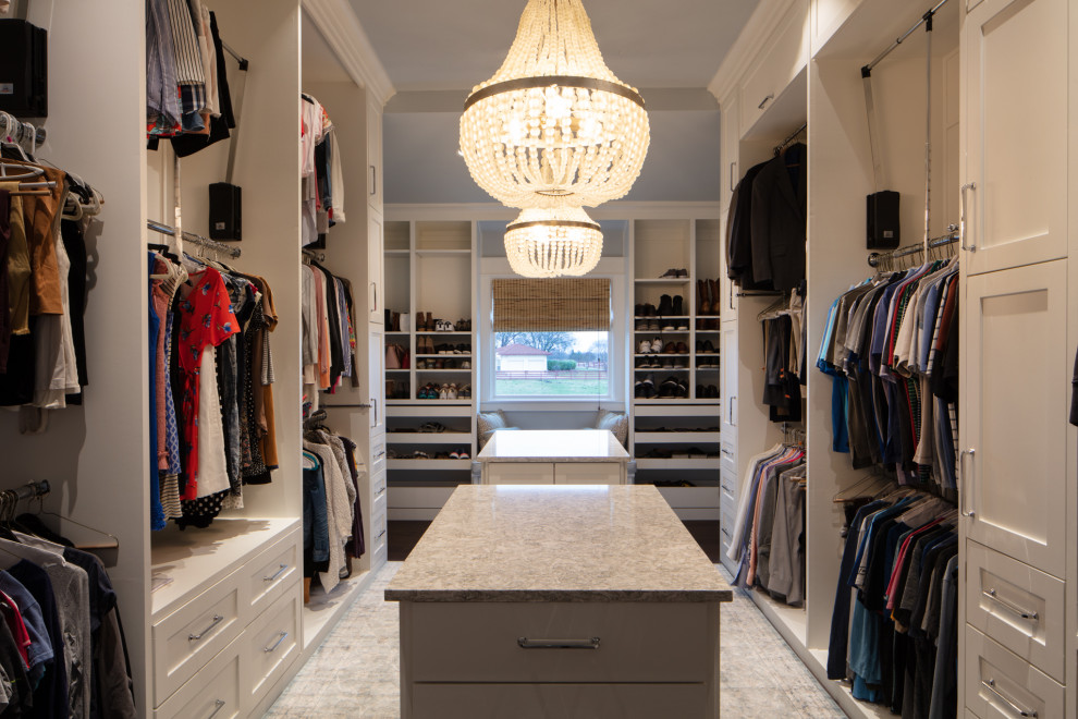 Design ideas for a large country gender-neutral walk-in wardrobe in Dallas with recessed-panel cabinets, yellow cabinets, porcelain floors and grey floor.