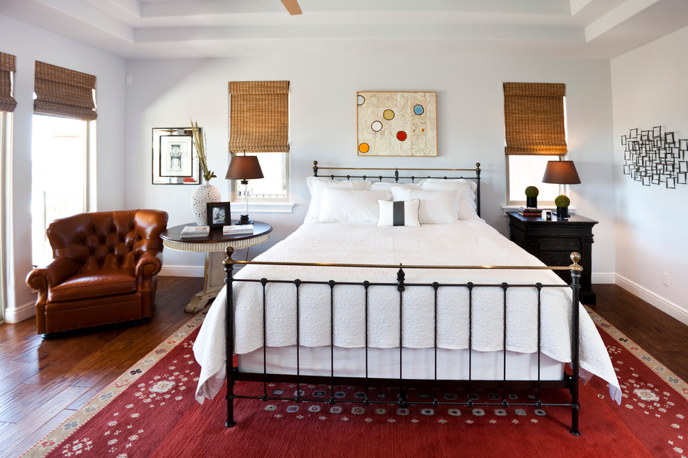 Country bedroom in Sacramento with white walls and dark hardwood floors.