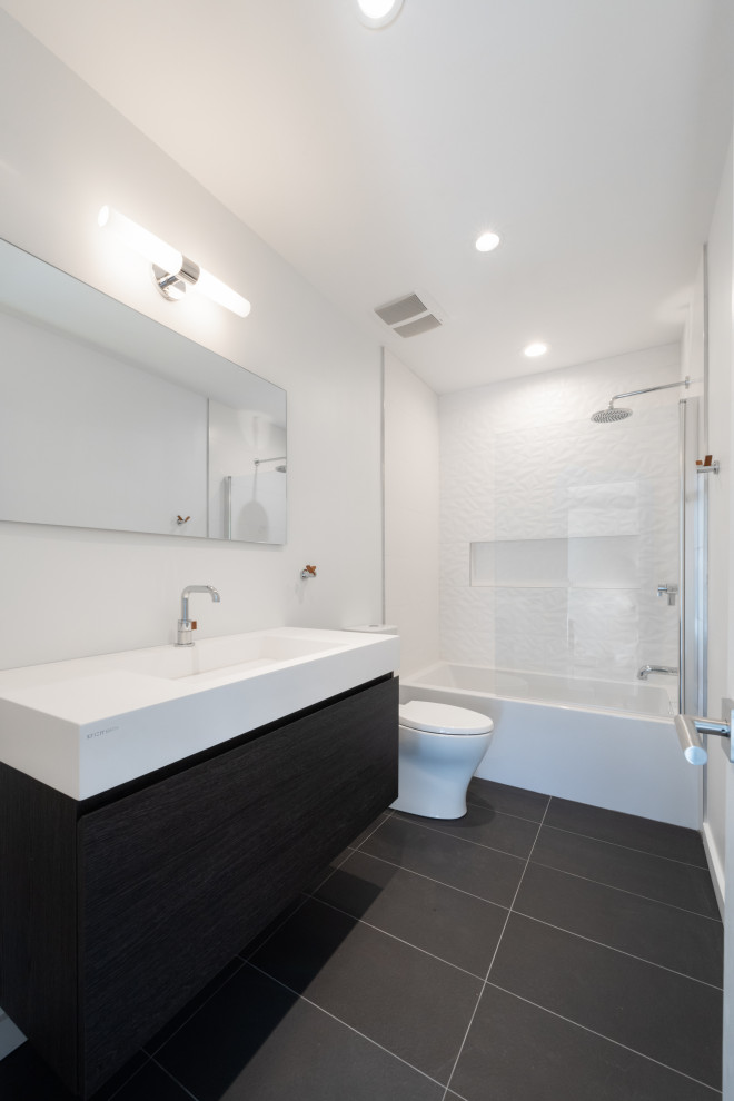 Inspiration for a mid-sized midcentury bathroom in Atlanta with black cabinets, an alcove tub, a shower/bathtub combo, white tile, white benchtops, a single vanity and a floating vanity.