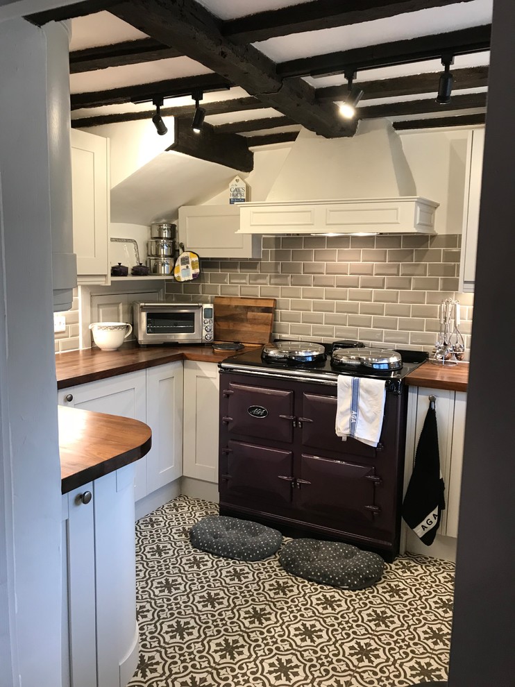 Inspiration for a small traditional u-shaped kitchen in Sussex with white cabinets, grey splashback, subway tile splashback, brown benchtop, shaker cabinets, wood benchtops, coloured appliances and multi-coloured floor.
