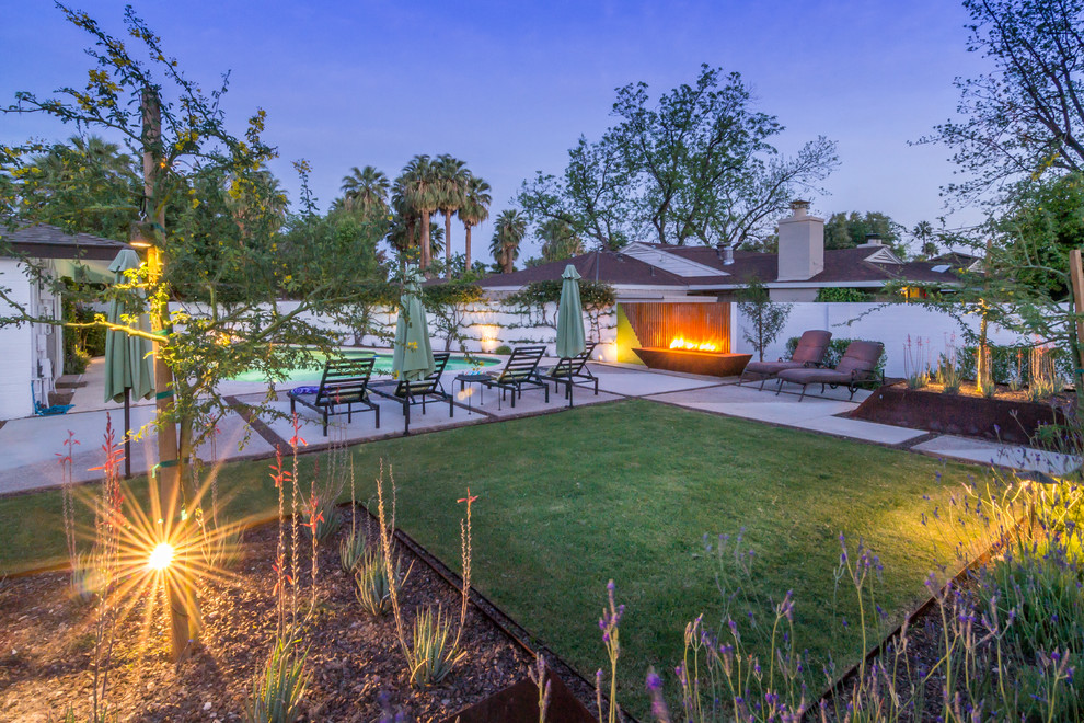 Photo of a large contemporary backyard patio in Phoenix with a fire feature, concrete slab and no cover.
