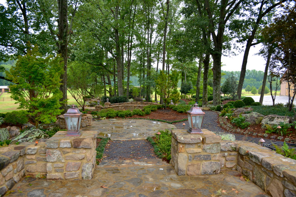Design ideas for a large traditional backyard shaded garden for summer in Other with a garden path and natural stone pavers.