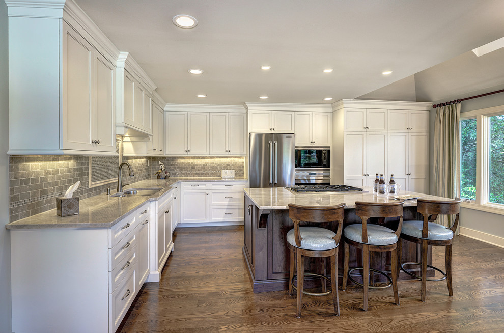 Large traditional u-shaped eat-in kitchen in Charleston with recessed-panel cabinets, white cabinets, granite benchtops and with island.