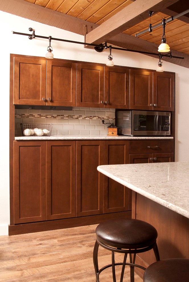 Kitchen - mid-sized transitional dark wood floor kitchen idea in Seattle with an undermount sink, shaker cabinets, dark wood cabinets, beige backsplash, subway tile backsplash, stainless steel appliances and a peninsula
