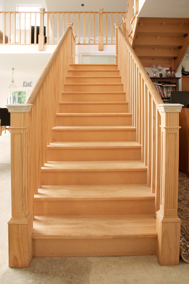 Photo of a country wood u-shaped staircase in Wellington with wood risers.