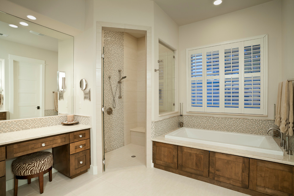Example of a transitional master beige tile and porcelain tile porcelain tile drop-in bathtub design in Austin with an undermount sink, medium tone wood cabinets, marble countertops and shaker cabinets