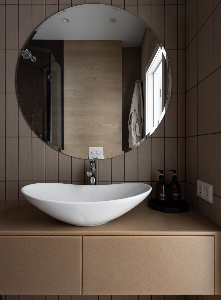 This is an example of a small scandinavian cloakroom in Yekaterinburg with flat-panel cabinets, beige cabinets, beige tiles, ceramic tiles, beige walls, porcelain flooring, a vessel sink, solid surface worktops, beige worktops and a floating vanity unit.
