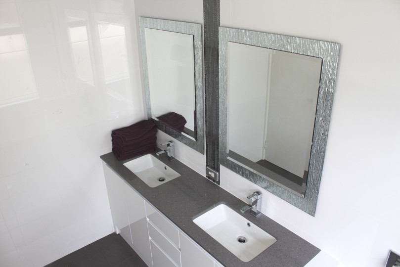 Large modern kids bathroom in Perth with raised-panel cabinets, white cabinets, a curbless shower, ceramic tile, white walls, porcelain floors, an undermount sink, engineered quartz benchtops, grey floor and a hinged shower door.