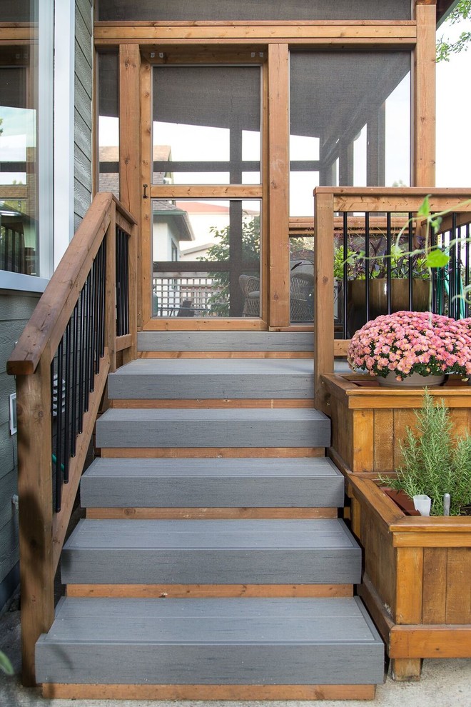 Example of a mid-sized transitional backyard deck design with a roof extension