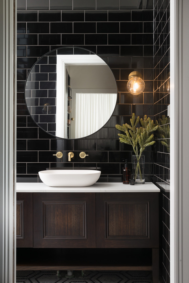 Small transitional bathroom in Hobart with beaded inset cabinets, dark wood cabinets, an open shower, black tile, ceramic tile, white walls, mosaic tile floors, a console sink, marble benchtops, white floor, an open shower and white benchtops.