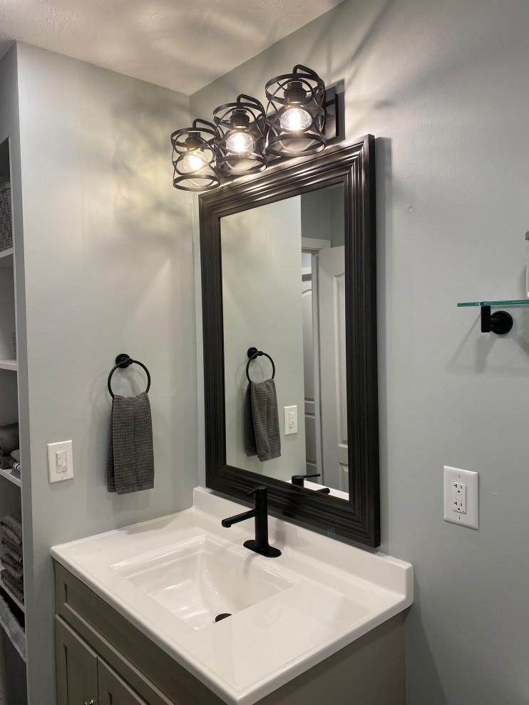 Inspiration for a large transitional l-shaped vinyl floor and gray floor open concept kitchen remodel in Cincinnati with an undermount sink, raised-panel cabinets, white cabinets, granite countertops, multicolored backsplash, ceramic backsplash, stainless steel appliances, an island and black countertops