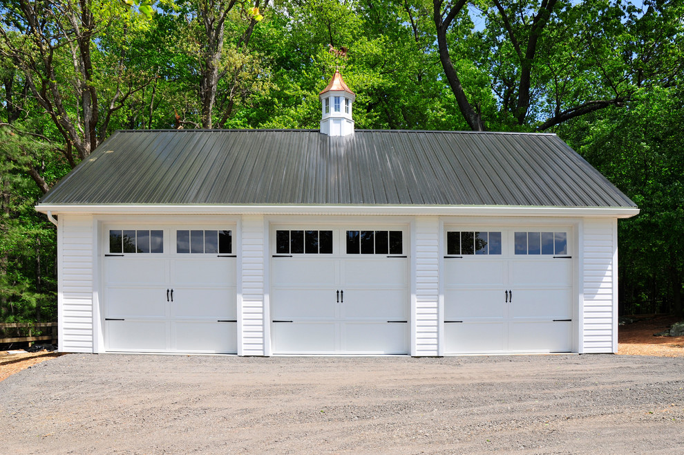 This is an example of a large traditional detached three-car garage in Other.