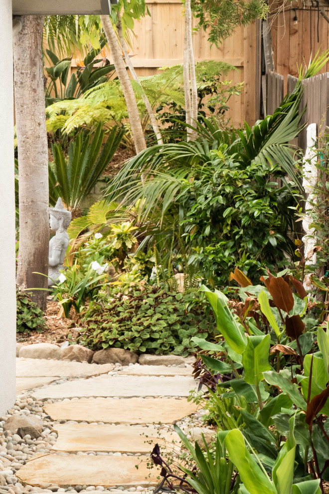 Design ideas for a mid-sized tropical drought-tolerant and partial sun side yard stone walkway in Santa Barbara.