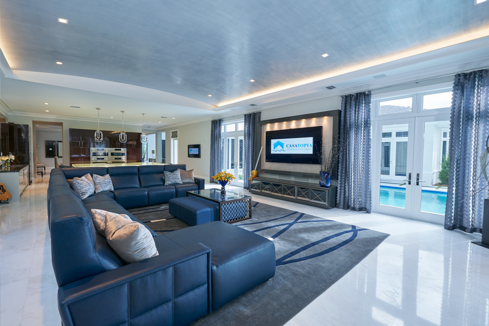 This is an example of an expansive contemporary open concept family room in Miami with beige walls, marble floors, no fireplace and a built-in media wall.