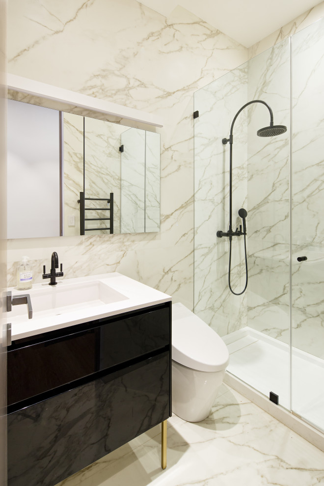 Photo of a small contemporary master bathroom in New York with flat-panel cabinets, black cabinets, an alcove shower, a one-piece toilet, white tile, marble, white walls, marble floors, a drop-in sink, soapstone benchtops, white floor, a hinged shower door, white benchtops, a single vanity and a freestanding vanity.