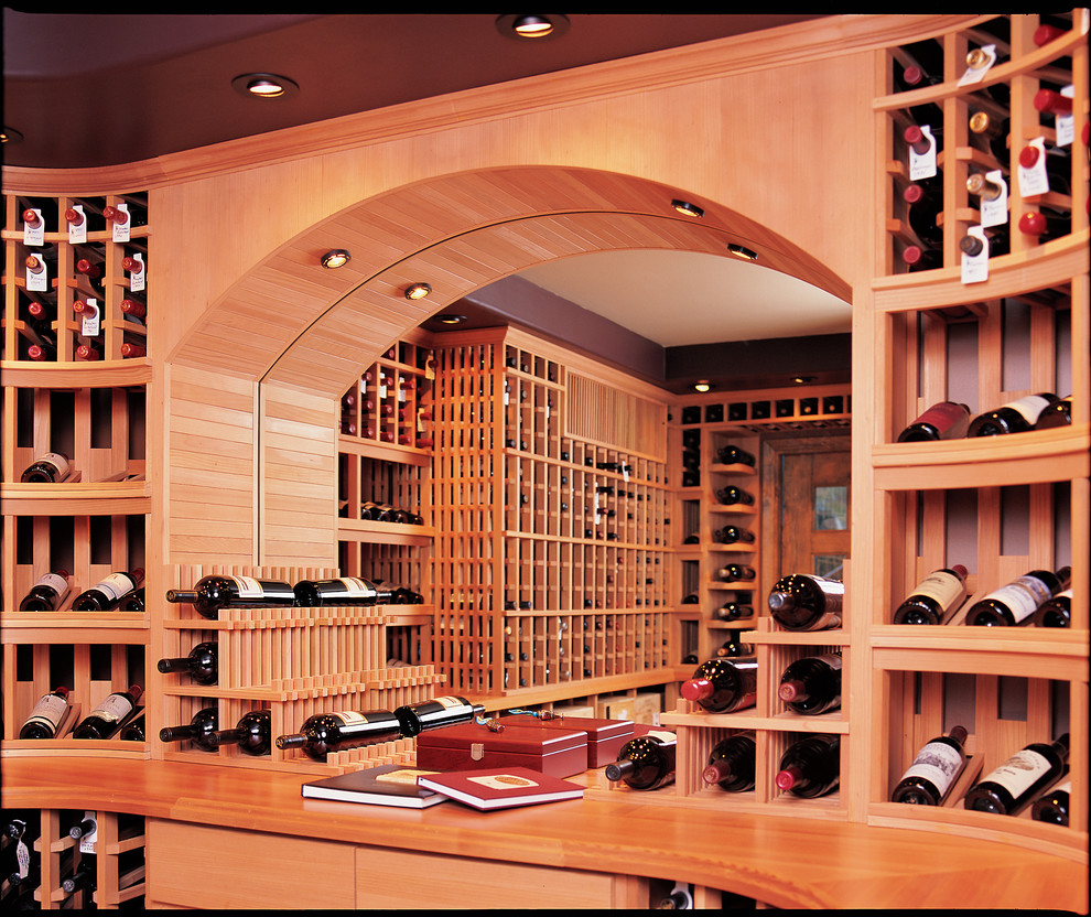 This is an example of a large arts and crafts wine cellar in San Diego with marble floors and display racks.