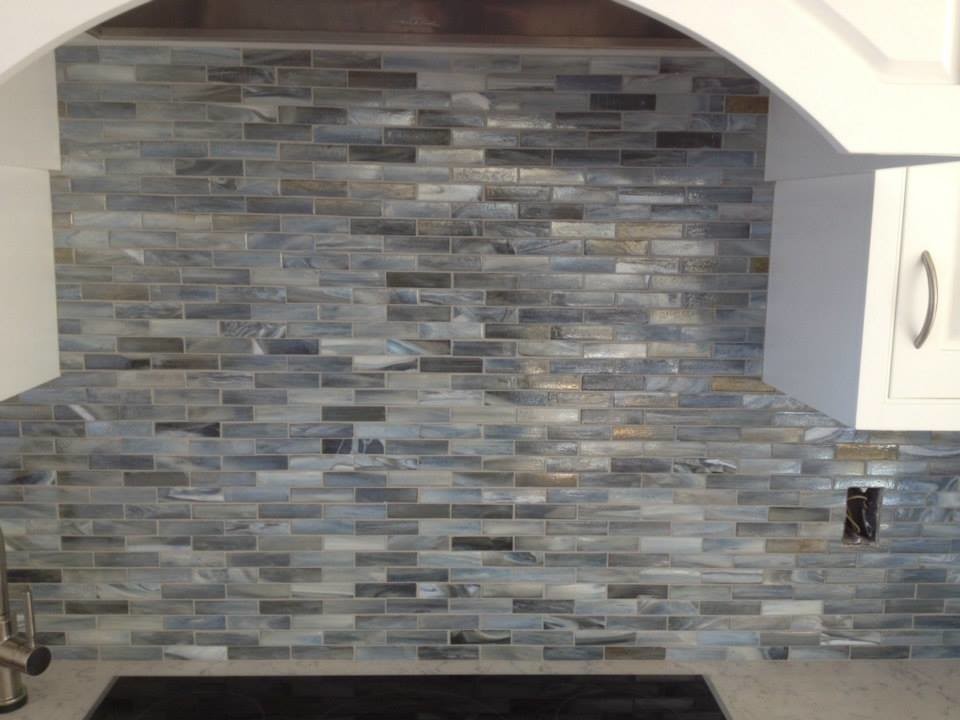 Kitchen - transitional kitchen idea in Boston with raised-panel cabinets, white cabinets, marble countertops, blue backsplash, glass tile backsplash and stainless steel appliances