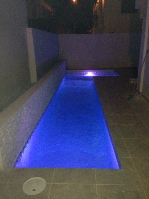 Pool - mid-sized modern side yard tile and l-shaped lap pool idea