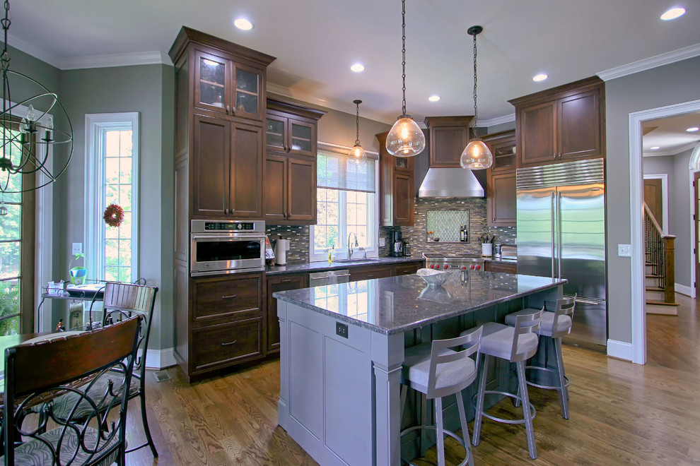 Large transitional medium tone wood floor eat-in kitchen photo in Charlotte with an undermount sink, flat-panel cabinets, stainless steel appliances and an island
