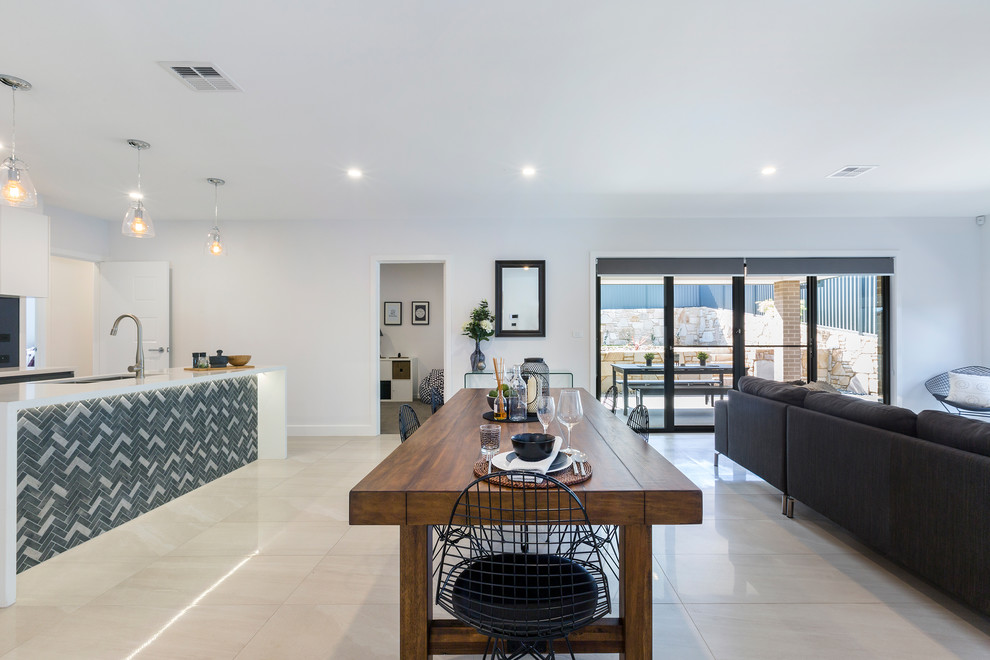 Small contemporary open plan dining in Canberra - Queanbeyan with white walls, ceramic floors and beige floor.