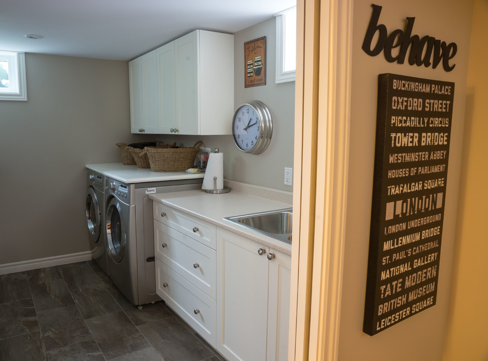 This is an example of a small contemporary galley dedicated laundry room in Toronto with a double-bowl sink, shaker cabinets, white cabinets, laminate benchtops, beige walls, porcelain floors and a side-by-side washer and dryer.
