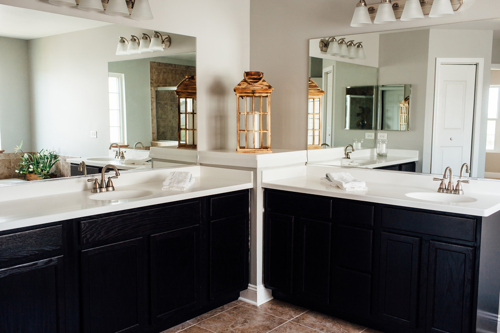 Large transitional master bathroom in Chicago with dark wood cabinets, solid surface benchtops, beige walls, ceramic floors and white benchtops.