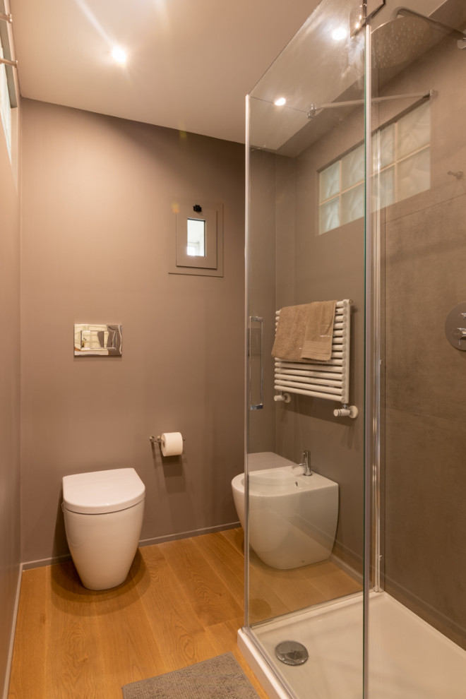 Inspiration for a small contemporary 3/4 bathroom in Other with flat-panel cabinets, white cabinets, a two-piece toilet, gray tile, grey walls, light hardwood floors, a vessel sink, wood benchtops, beige floor, a hinged shower door, beige benchtops, a single vanity, a built-in vanity and recessed.
