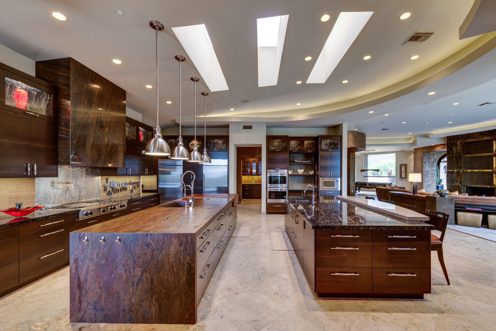 This is an example of a contemporary kitchen in Phoenix with an undermount sink, flat-panel cabinets, dark wood cabinets, beige splashback, stainless steel appliances and multiple islands.