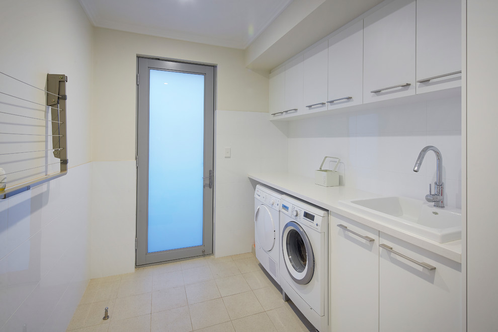 Photo of a mid-sized contemporary single-wall laundry room in Perth with white cabinets, laminate benchtops and porcelain floors.