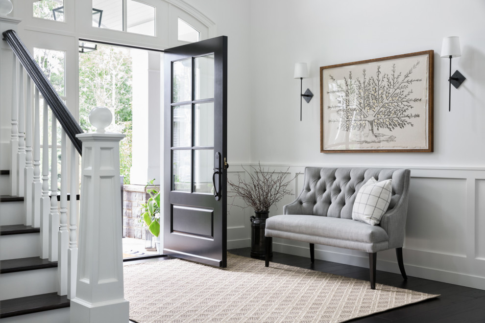 Inspiration for a transitional foyer in Vancouver with white walls, dark hardwood floors, a single front door, a black front door, black floor and decorative wall panelling.