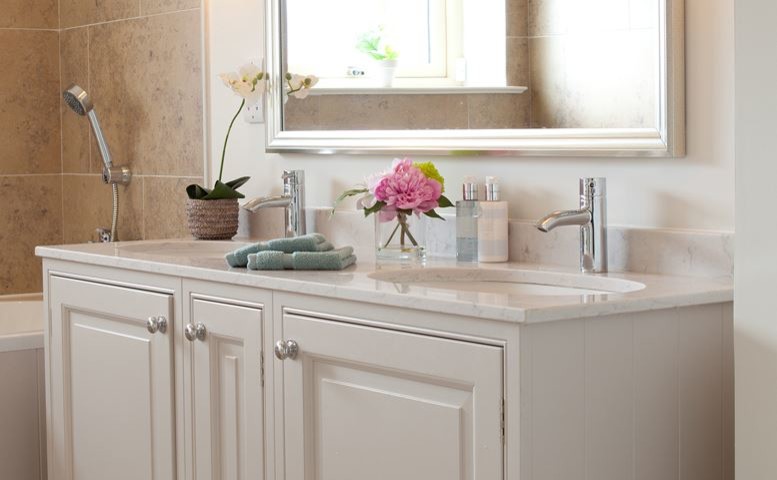 Design ideas for a traditional master bathroom in Dublin with raised-panel cabinets and engineered quartz benchtops.
