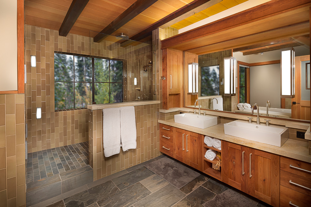 Large country master bathroom in Sacramento with a vessel sink, shaker cabinets, medium wood cabinets, limestone benchtops, an alcove shower, ceramic tile, white walls, slate floors and brown tile.