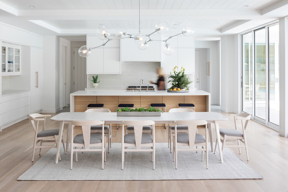 Design ideas for a beach style open plan dining in Minneapolis with white walls, light hardwood floors and beige floor.