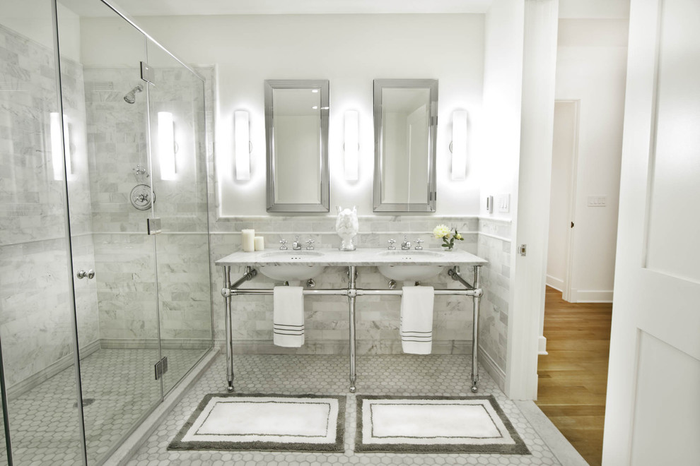 Large traditional master bathroom in New York with subway tile, open cabinets, a freestanding tub, a corner shower, a one-piece toilet, gray tile, white walls, marble floors, a pedestal sink, marble benchtops, grey floor, a hinged shower door and grey benchtops.