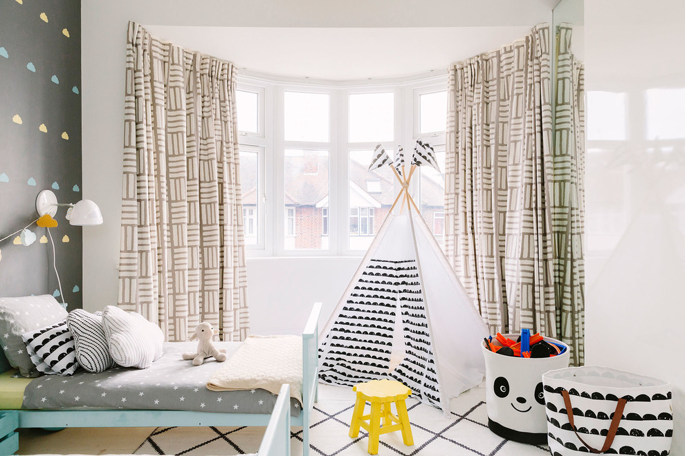 Inspiration for a modern gender-neutral kids' bedroom for kids 4-10 years old in London with grey walls.