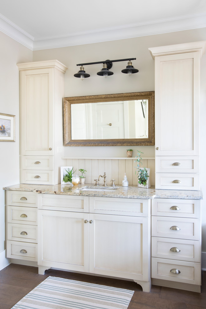 Design ideas for a country master bathroom in Charleston with shaker cabinets, white cabinets, beige walls, dark hardwood floors, an undermount sink, granite benchtops, brown floor and grey benchtops.
