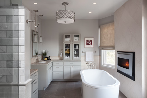 The combination of subway tile and small format tiling in the shower is in gray, a particularly popular neutral these days. The gas fireplace next to the soaking tub is a particularly nice addition.