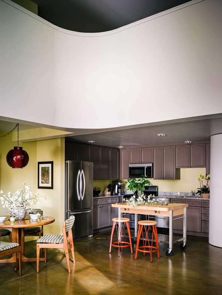 Inspiration for a small eclectic l-shaped open plan kitchen in San Francisco with an undermount sink, shaker cabinets, brown cabinets, marble benchtops, grey splashback, marble splashback, stainless steel appliances, concrete floors, with island, beige floor, grey benchtop and wood.