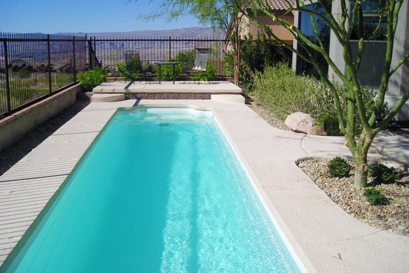 Large elegant backyard concrete and rectangular lap pool photo