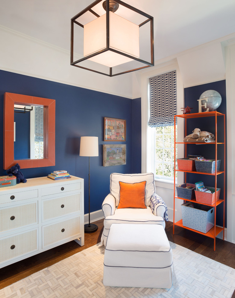 This is an example of a mid-sized contemporary kids' bedroom for boys in Chicago with blue walls, dark hardwood floors and brown floor.