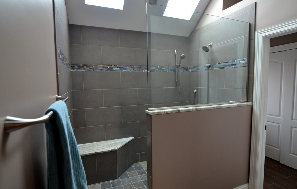 Photo of a large transitional bathroom in Other with an undermount sink, recessed-panel cabinets, dark wood cabinets, granite benchtops, an open shower, a two-piece toilet, gray tile, porcelain tile, grey walls and porcelain floors.