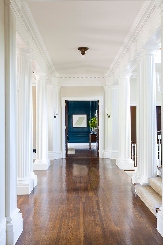 Expansive traditional foyer in New York with beige walls, dark hardwood floors, a double front door and a dark wood front door.