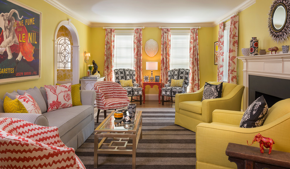 Design ideas for an eclectic formal living room in Providence with yellow walls, medium hardwood floors, a standard fireplace and a stone fireplace surround.