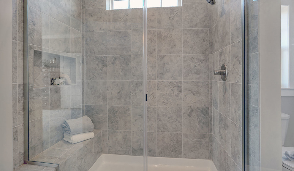 Mid-sized traditional master bathroom in Other with grey cabinets, an alcove shower, gray tile, beige walls, ceramic floors, an integrated sink, engineered quartz benchtops, grey floor and a hinged shower door.