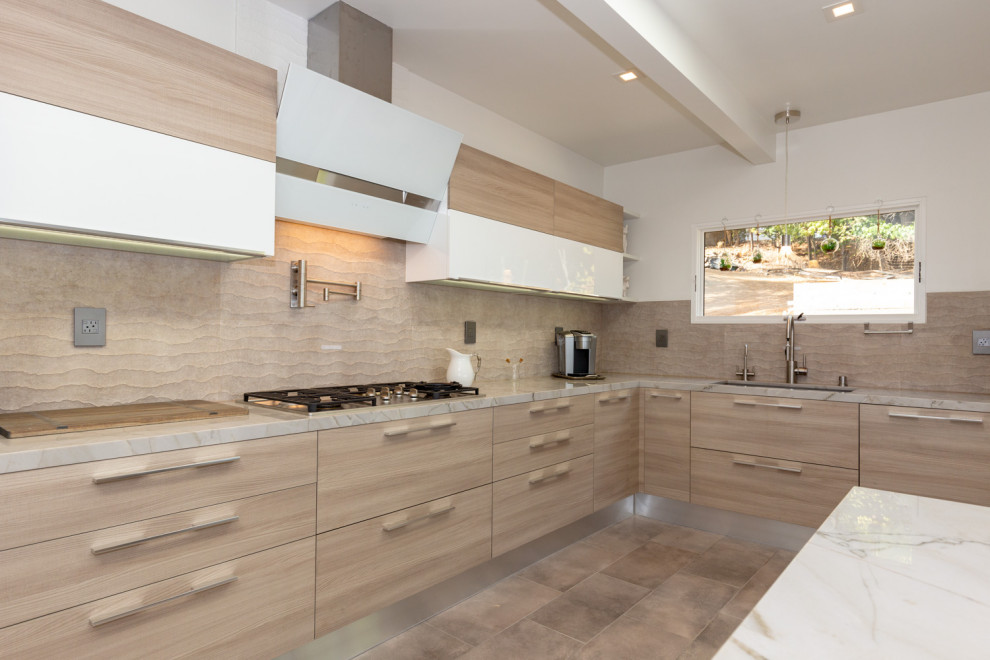 Design ideas for a large contemporary l-shaped open plan kitchen in San Francisco with an undermount sink, flat-panel cabinets, light wood cabinets, granite benchtops, brown splashback, glass tile splashback, stainless steel appliances, with island and brown benchtop.