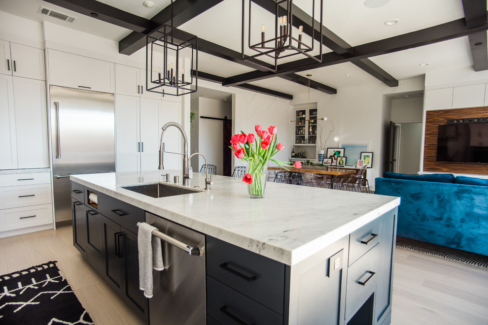 Photo of a large transitional l-shaped open plan kitchen in San Francisco with a single-bowl sink, shaker cabinets, white cabinets, marble benchtops, white splashback, subway tile splashback, stainless steel appliances, light hardwood floors and with island.