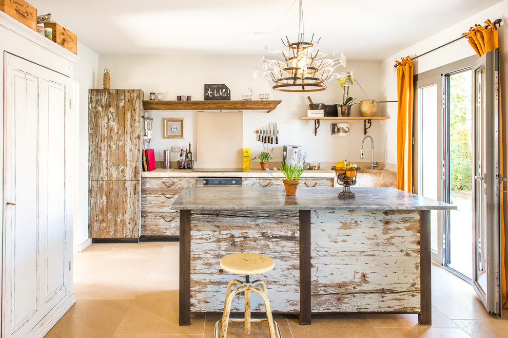 Photo of a mid-sized eclectic single-wall separate kitchen in Other with distressed cabinets, a drop-in sink, beaded inset cabinets, limestone benchtops, beige splashback, limestone splashback, stainless steel appliances, limestone floors, with island, beige floor and beige benchtop.