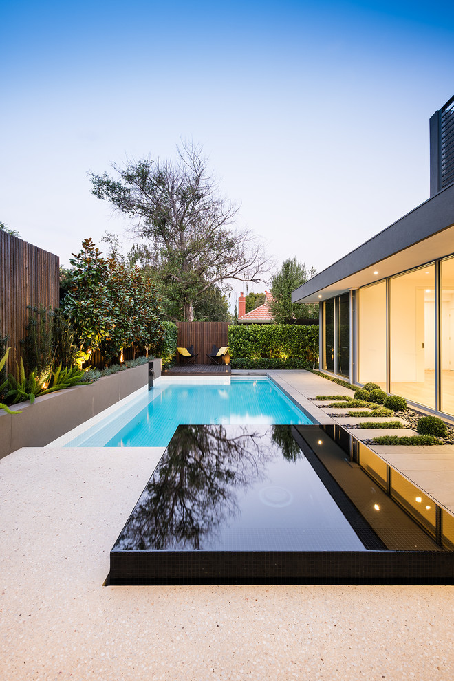 Photo of a modern pool in Melbourne with a hot tub.